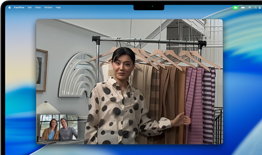 A video call on a MacBook Pro where a woman shows fabrics to two people on the call, with Center Stage keeping her centered in the frame as she moves around